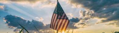 American flag at sunrise representing where America stands right now amid economic and institutional change