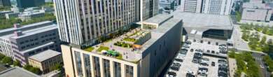 Architectural aerial rendering of the proposed Cincinnati Convention Headquarters Hotel, featuring a tall modern tower and lower terraced sections with green roofs.