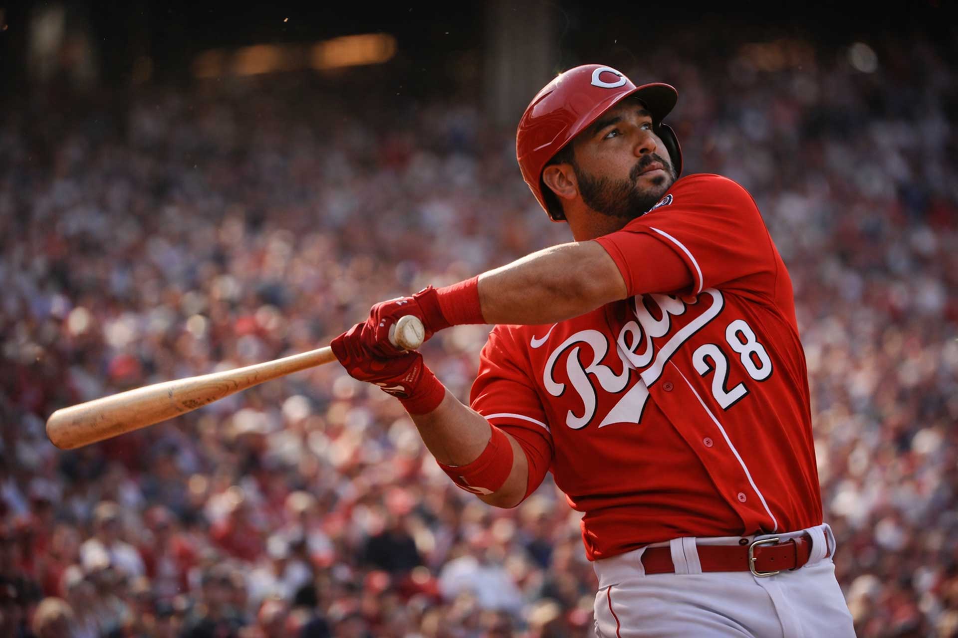 Eugenio Suárez wearing number 28 swings the bat for the Cincinnati Reds during a game at Great American Ball Park.