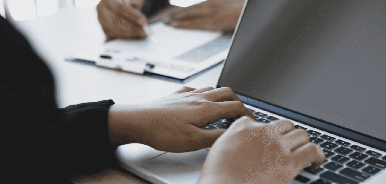 Close-up of hands typing on a laptop, illustrating the Ohio tech boom and startup funding growth.