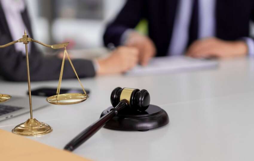 A wooden gavel and brass scales of justice on a courtroom desk, used as a featured image for news coverage of the Afroman lawsuit verdict in Adams County.