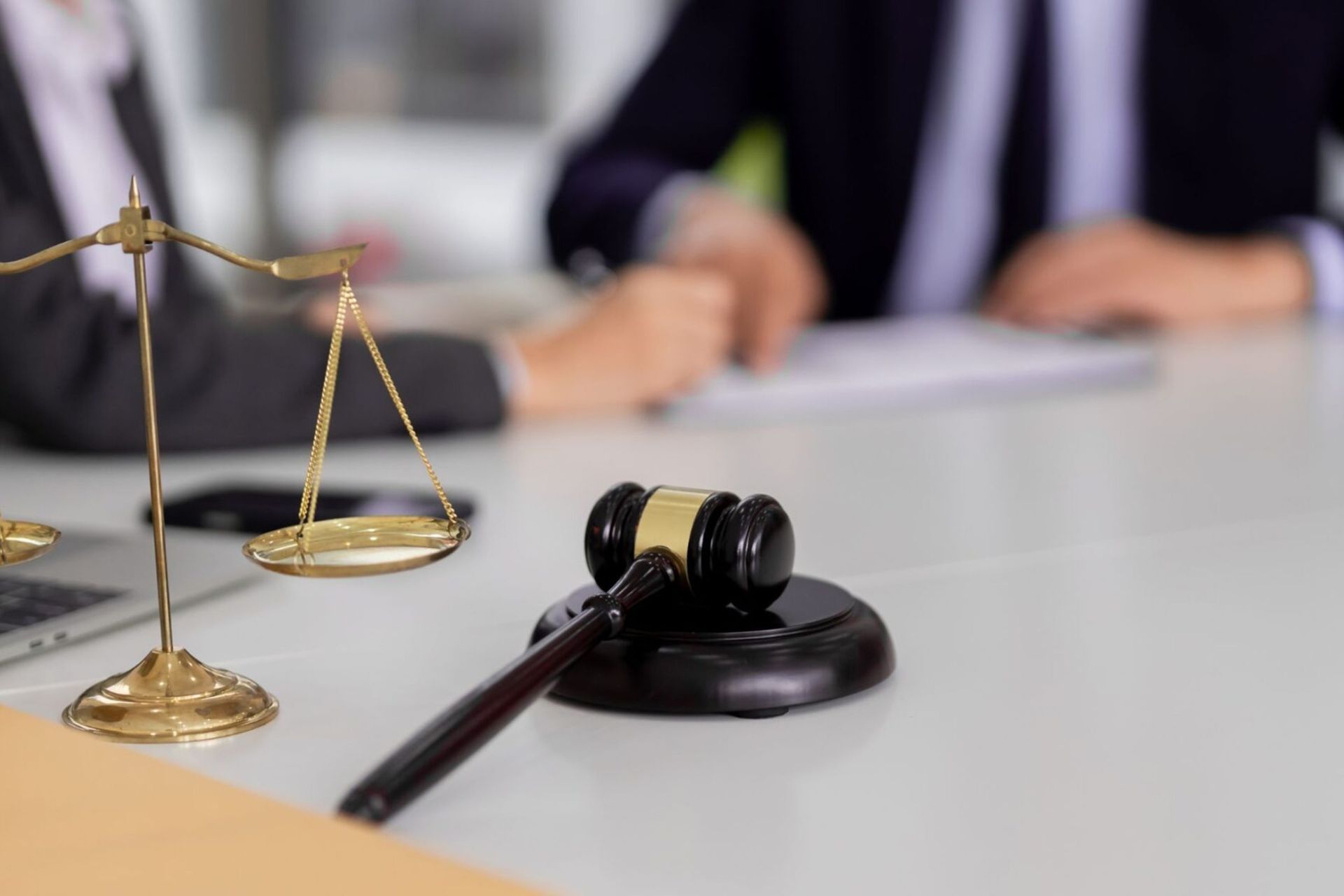 A wooden gavel and brass scales of justice on a courtroom desk, used as a featured image for news coverage of the Afroman lawsuit verdict in Adams County.