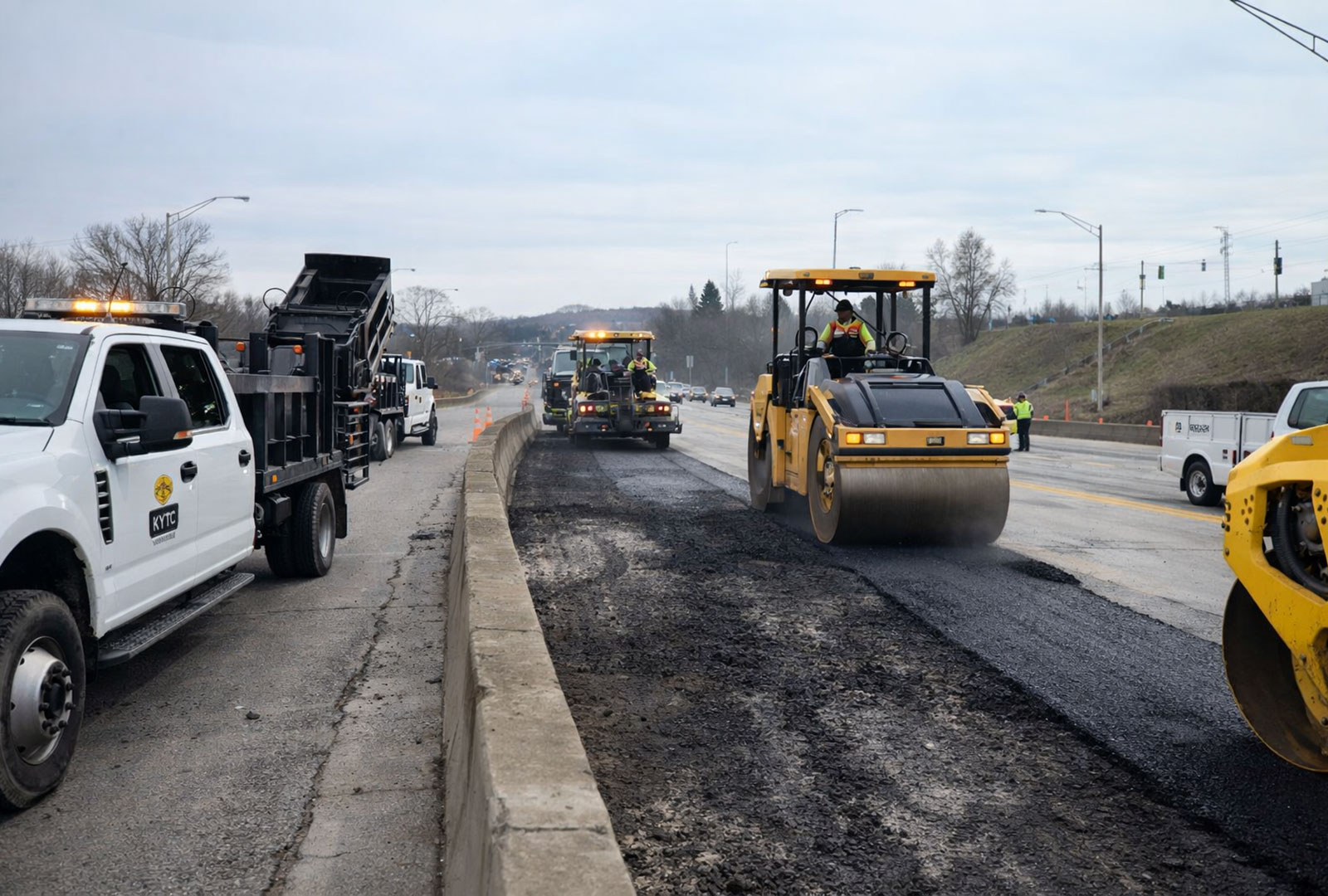 Road crews repave damaged lanes on Interstate 471 in Newport Kentucky after a gasoline tanker explosion burned sections of the roadway