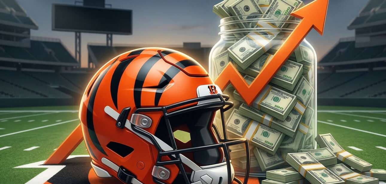 A Cincinnati Bengals football helmet sitting on a field next to stacks of cash, money bags, and an upward-pointing orange arrow, illustrating financial growth or a bonus.