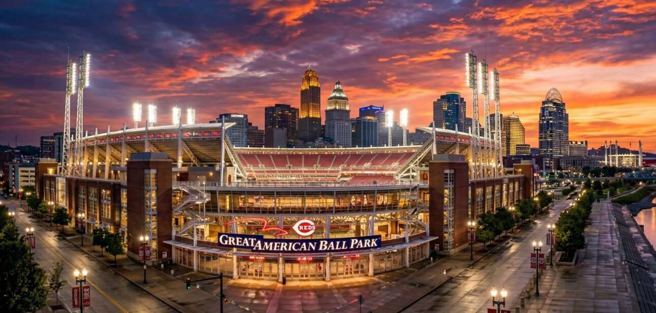 A wide-angle, cinematic view of the Great American Ball Park exterior in Cincinnati at sunset with the city skyline in the background.