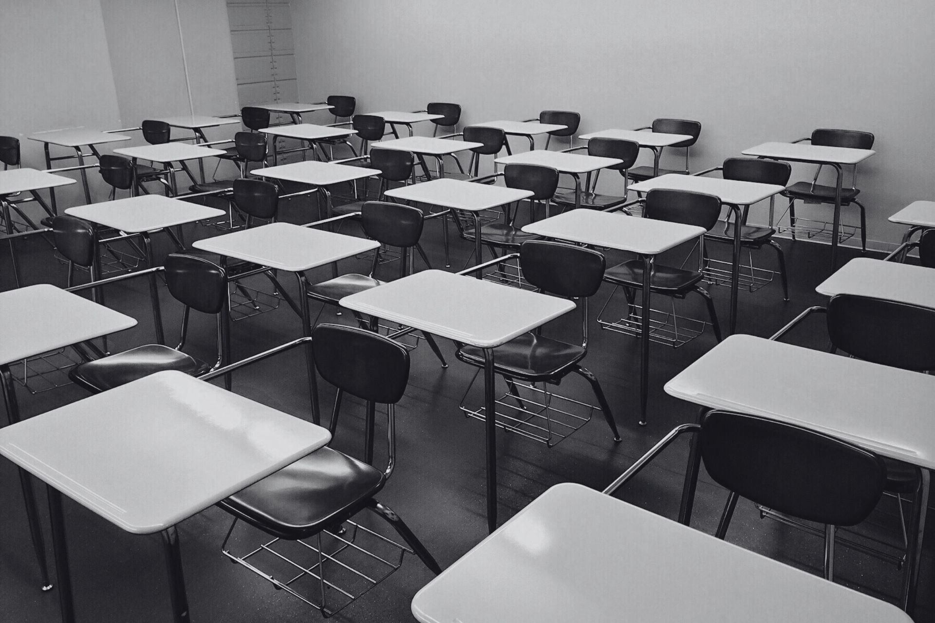 Empty classroom with rows of student desks, representing the evacuation of suburban schools in Indian Hill due to a bomb threat.