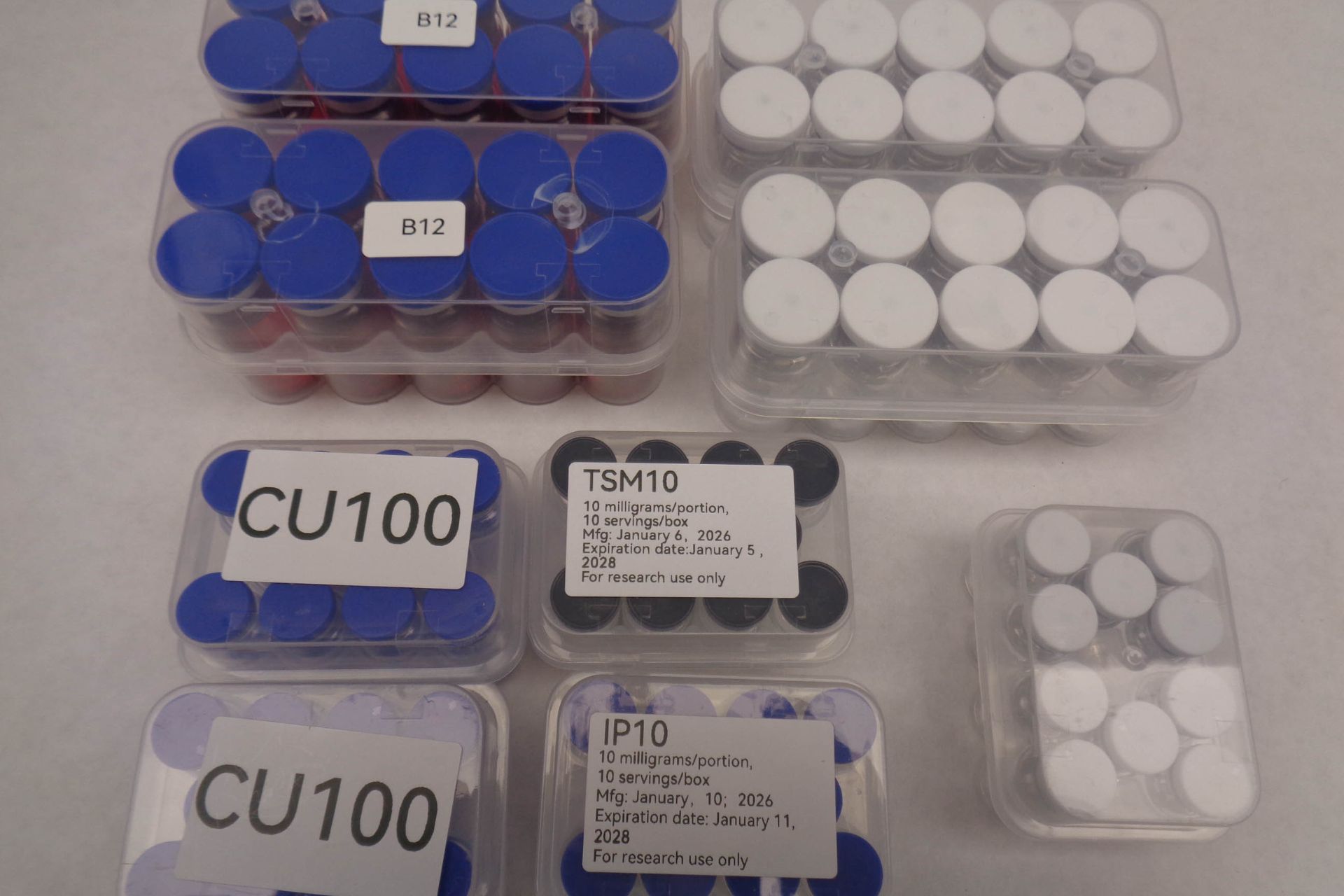 Several trays of confiscated peptide vials and medical bottles labeled CU100 and TSH10 from a CBP seizure in Cincinnati.