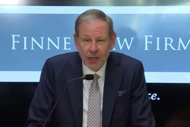 Attorney Stephen Imm speaking at a microphone during a press conference at Finney Law Firm regarding the legal challenge to the firing of Cincinnati Police Chief Teresa Theetge.