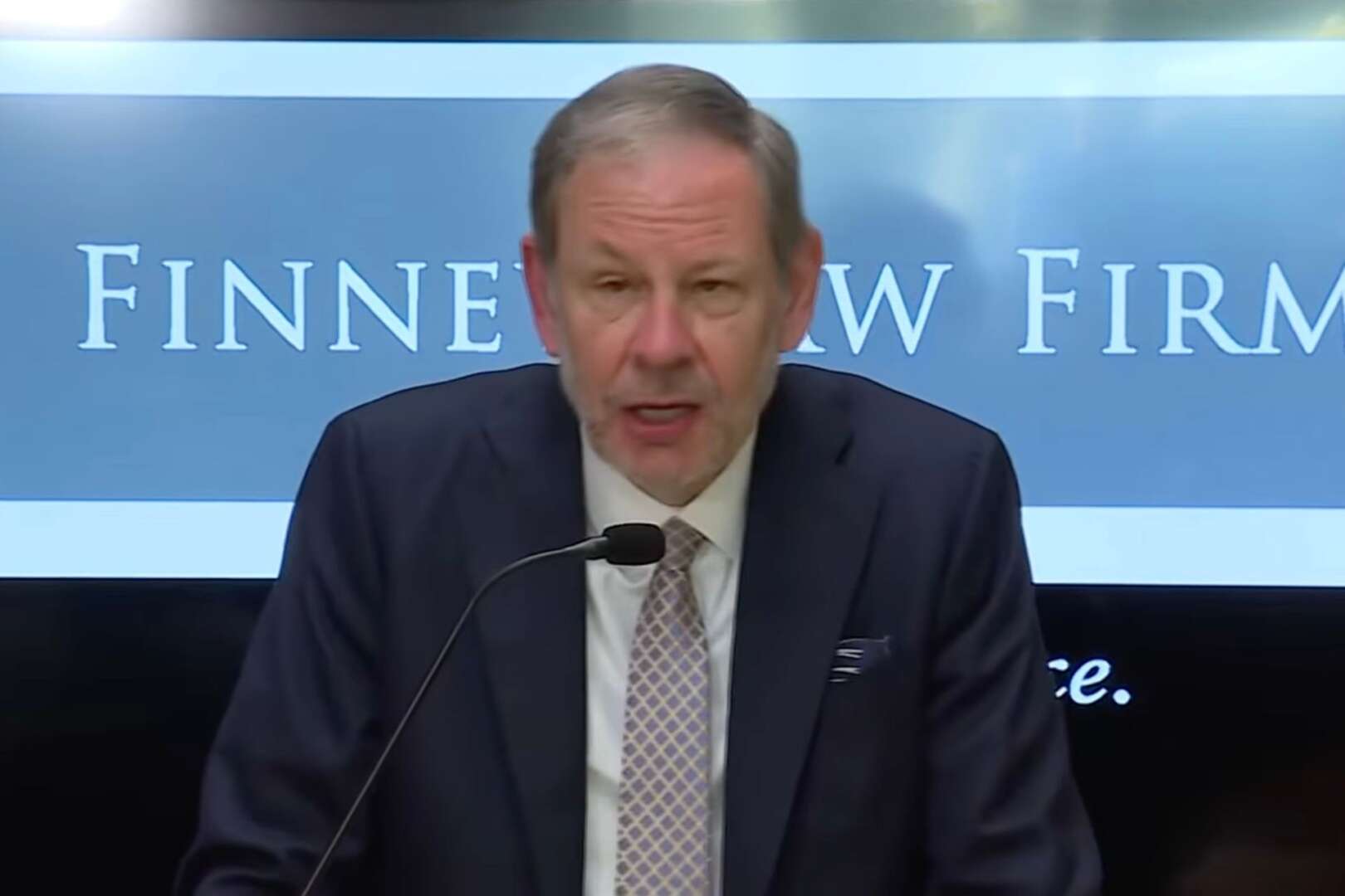Attorney Stephen Imm speaking at a microphone during a press conference at Finney Law Firm regarding the legal challenge to the firing of Cincinnati Police Chief Teresa Theetge.