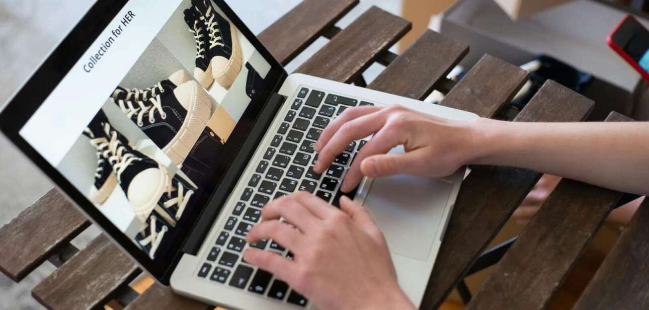 Person typing on laptop analyzing Cincinnati digital economy ecommerce growth charts, tracking Cincinnati online business digital sales data in Ohio and Northern Kentucky.