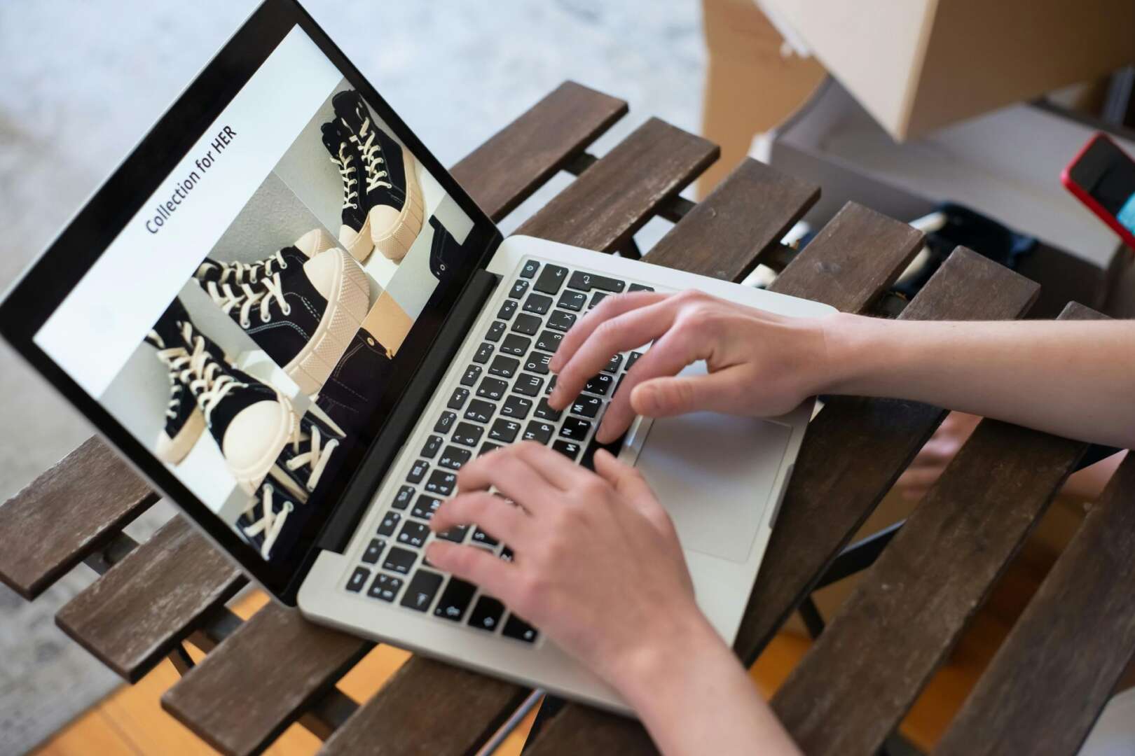 Person typing on laptop analyzing Cincinnati digital economy ecommerce growth charts, tracking Cincinnati online business digital sales data in Ohio and Northern Kentucky.