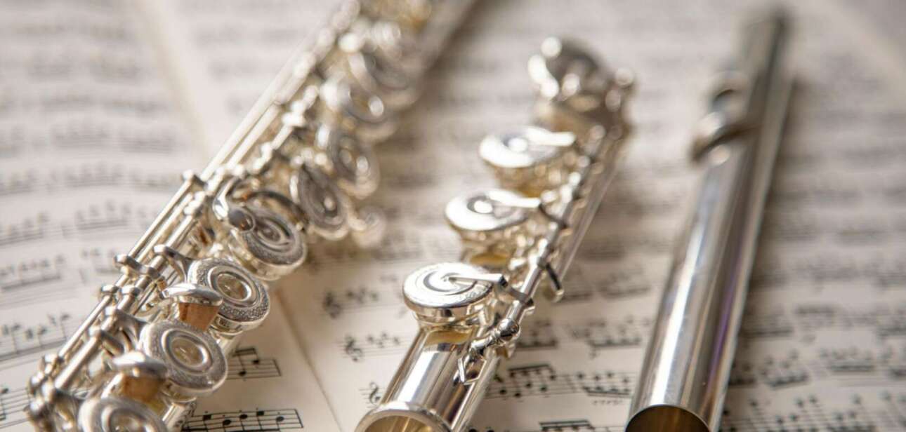 Disassembled silver flute on sheet music representing the Cincinnati court restitution case.