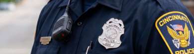Cincinnati Police Department officer in uniform during the investigation and dismissal of the police chief.