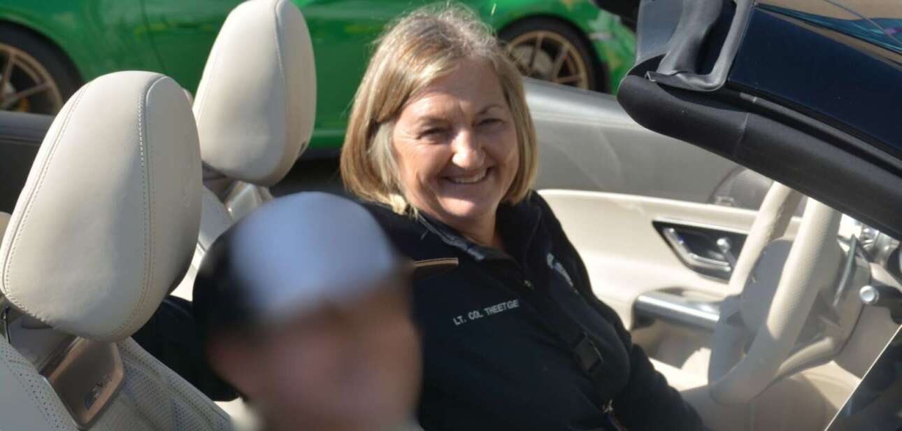 Cincinnati Police Chief Teresa Theetge smiling in a convertible car.