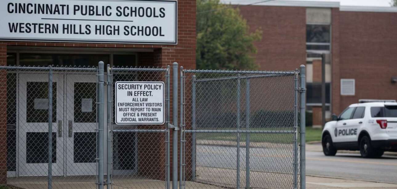 Western Hills High School entrance in Cincinnati featuring a security sign requiring law enforcement to present judicial warrants, following unauthorized ICE-related school visits.