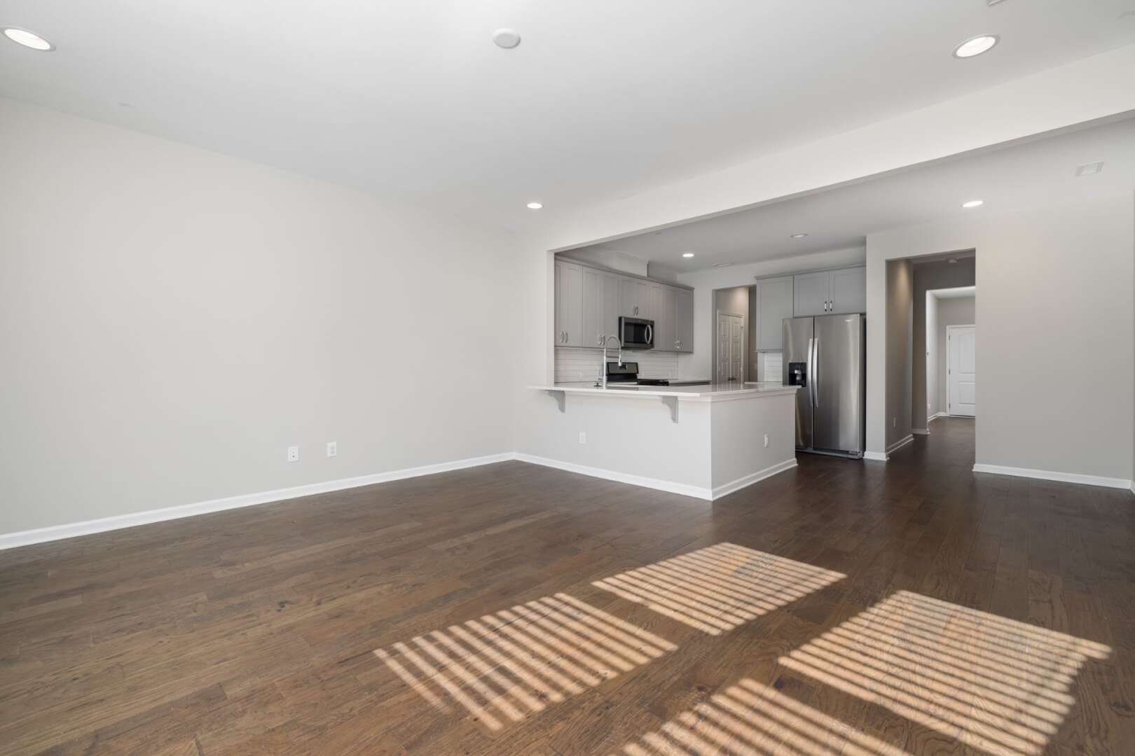 An empty, newly renovated apartment interior with hardwood floors, representing the impact of fluctuating Cincinnati apartment vacancy rates on available local housing.