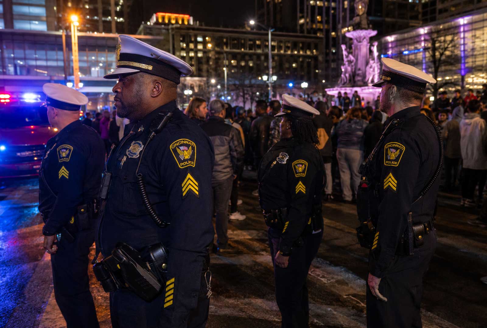 Cincinnati police officers monitoring downtown Cincinnati juvenile crowds near Fountain Square at night