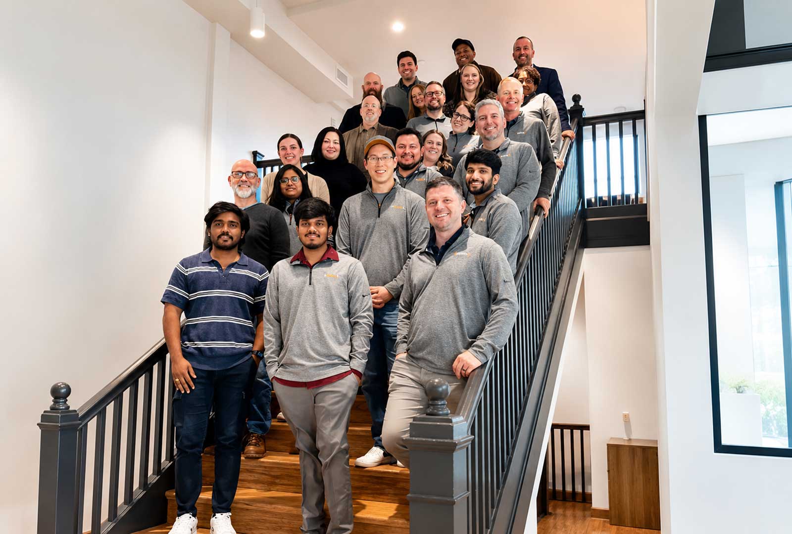 Team members gather on the staircase inside SparkHaus in Covington, Kentucky, highlighting the Covington startup fellowship and Northern Kentucky's growing entrepreneurial community.