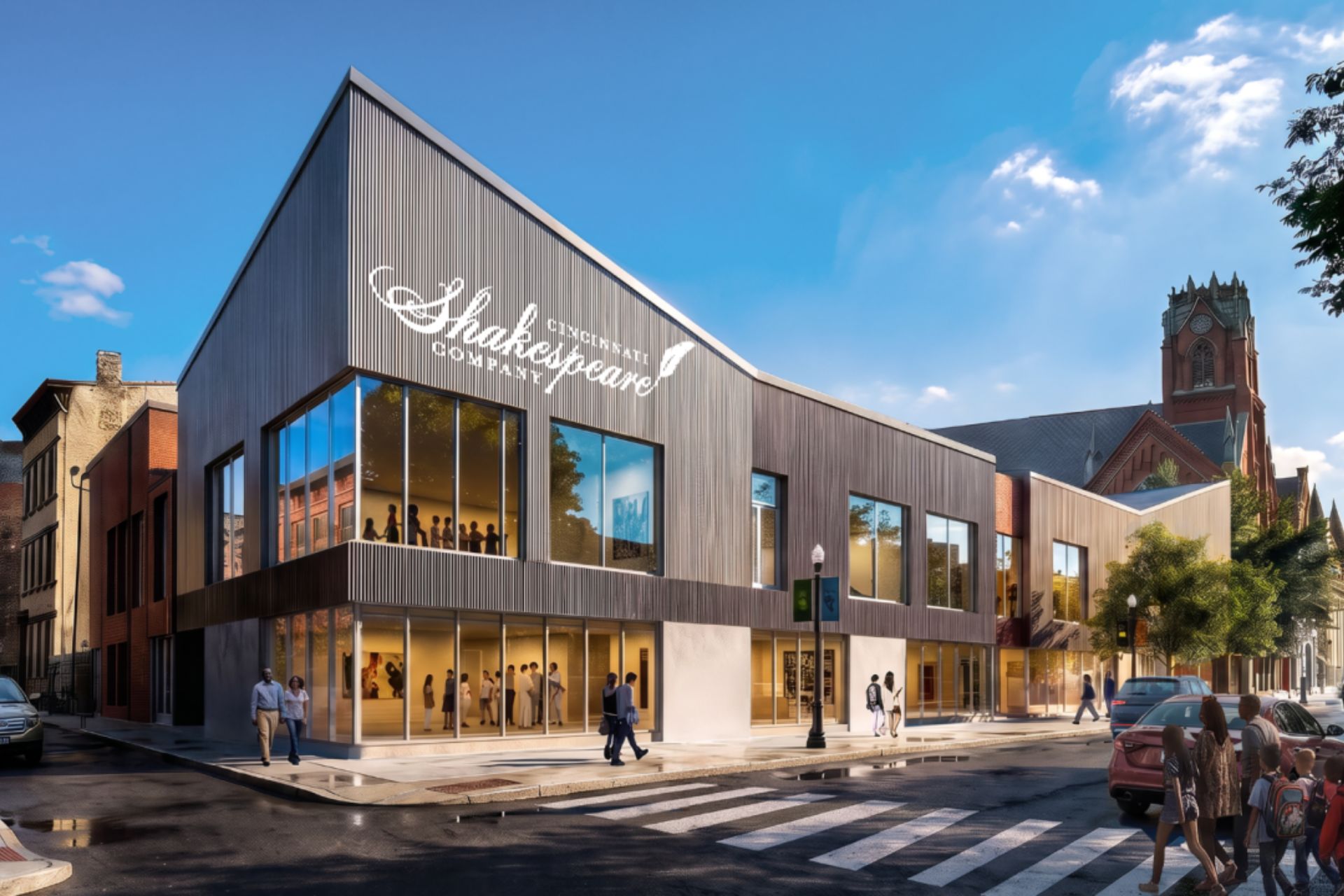 Exterior view of the modern Cincinnati Shakespeare Company building lit up on a city street corner in Cincinnati, Ohio.