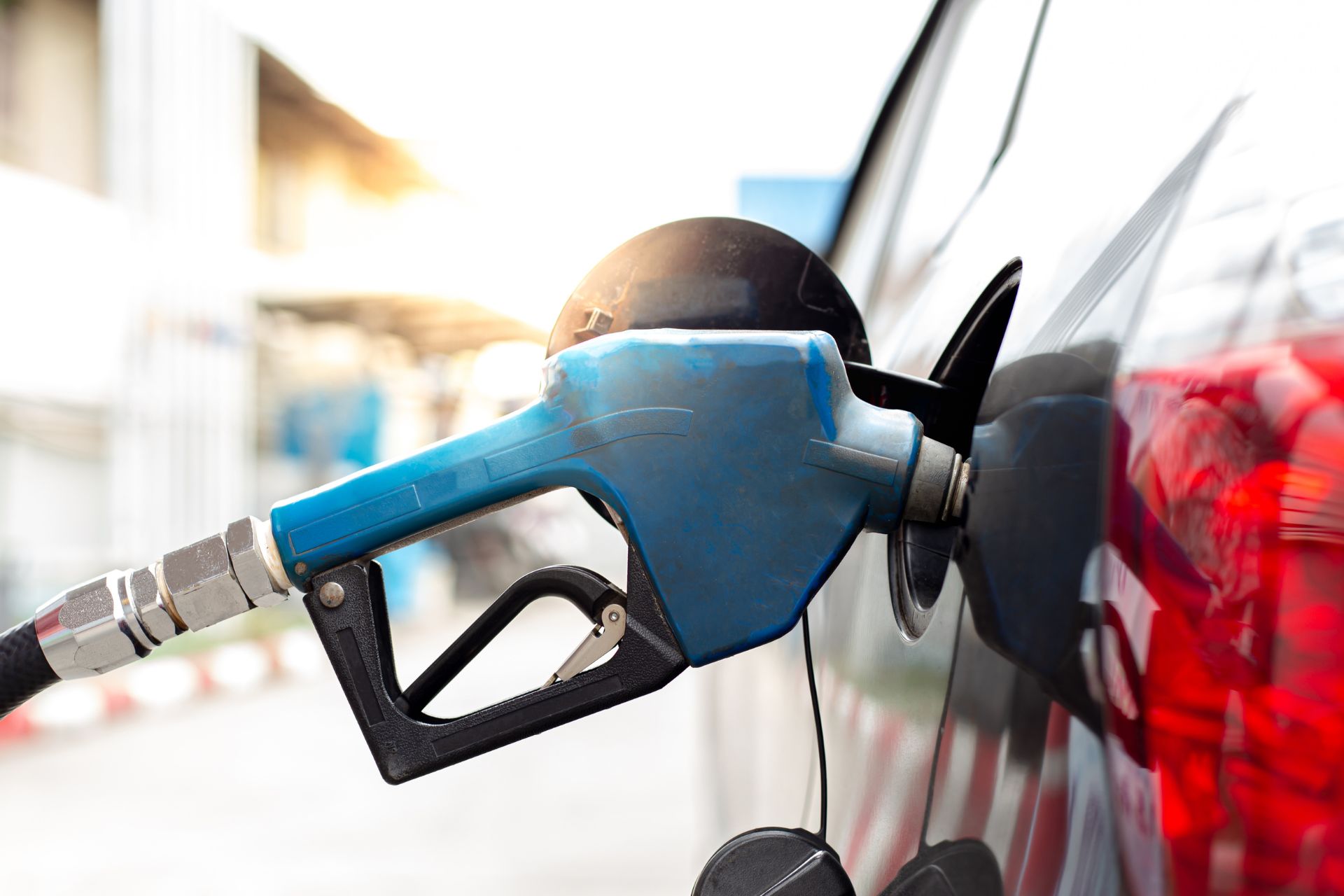 Blue fuel pump nozzle dispensing diesel, illustrating rising fuel costs for Cincinnati drivers.