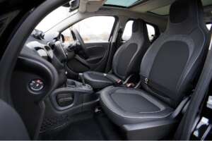 Interior view of an empty vehicle showing the front driver and passenger seats, steering wheel, and dashboard.