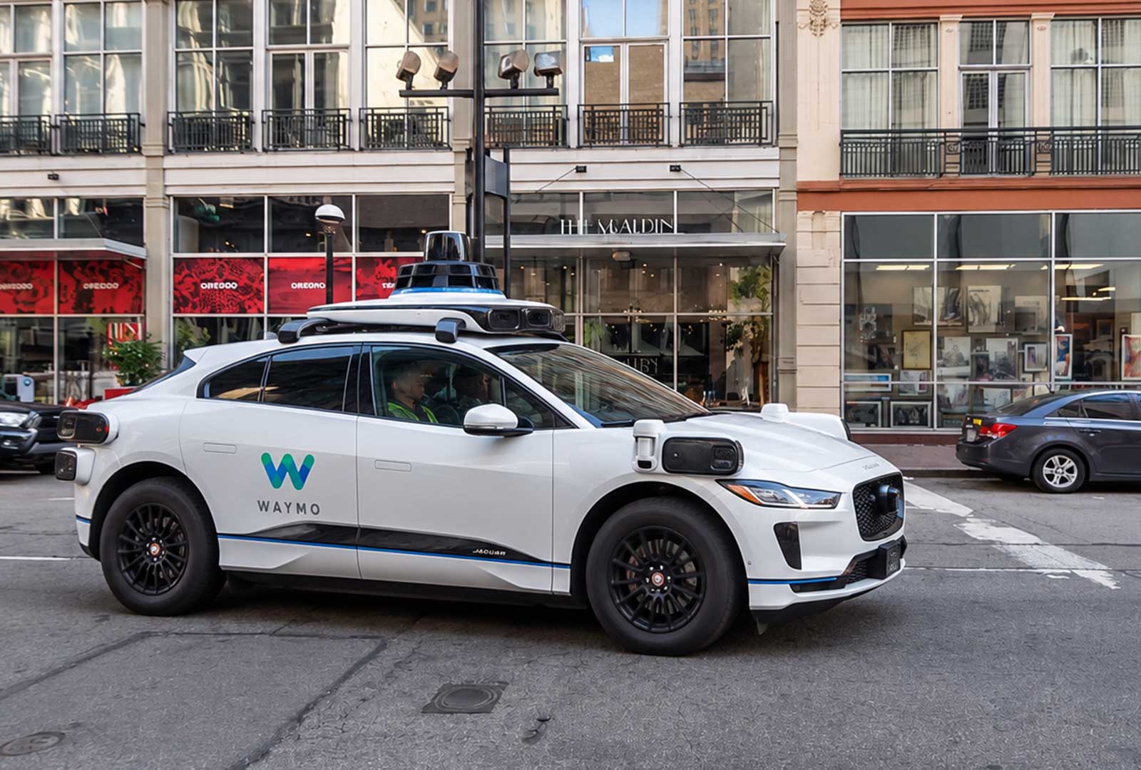 Waymo Cincinnati autonomous vehicle driving on a downtown Cincinnati street during mapping
