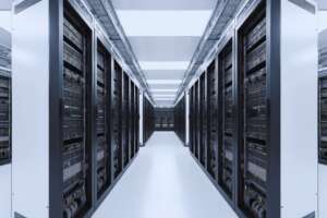 Long aisle between rows of server racks inside a data center
