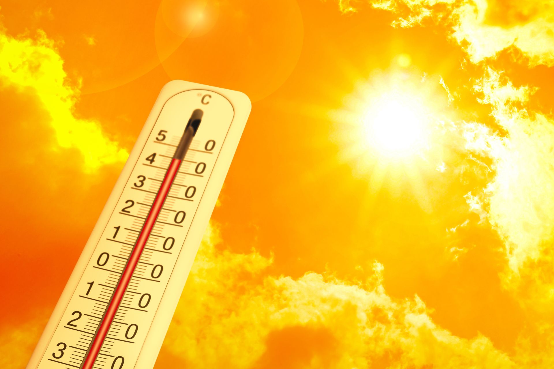 Thermometer in front of a blazing sun and orange sky, symbolizing record heat