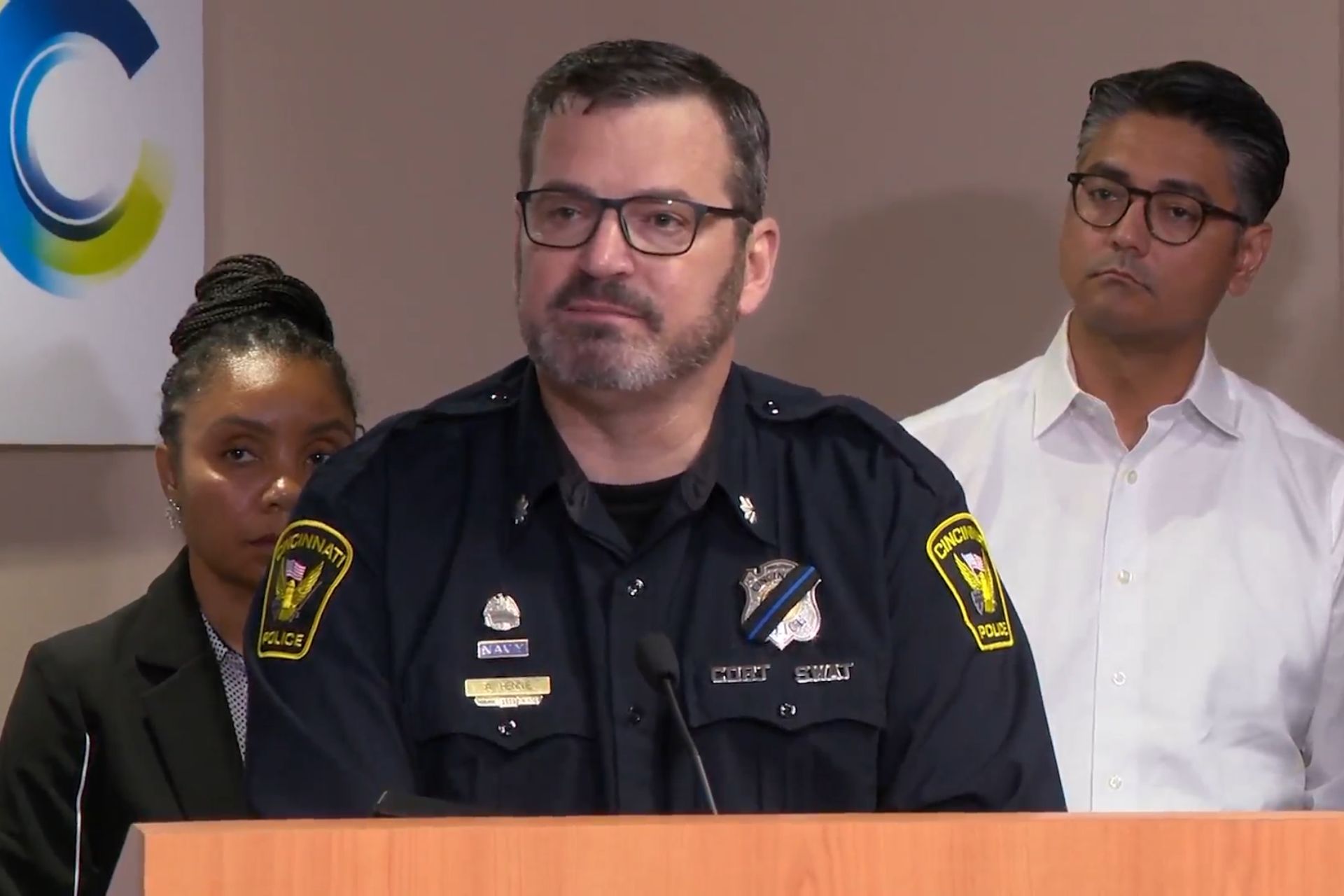 A high-ranking Cincinnati police officer speaking at a podium.