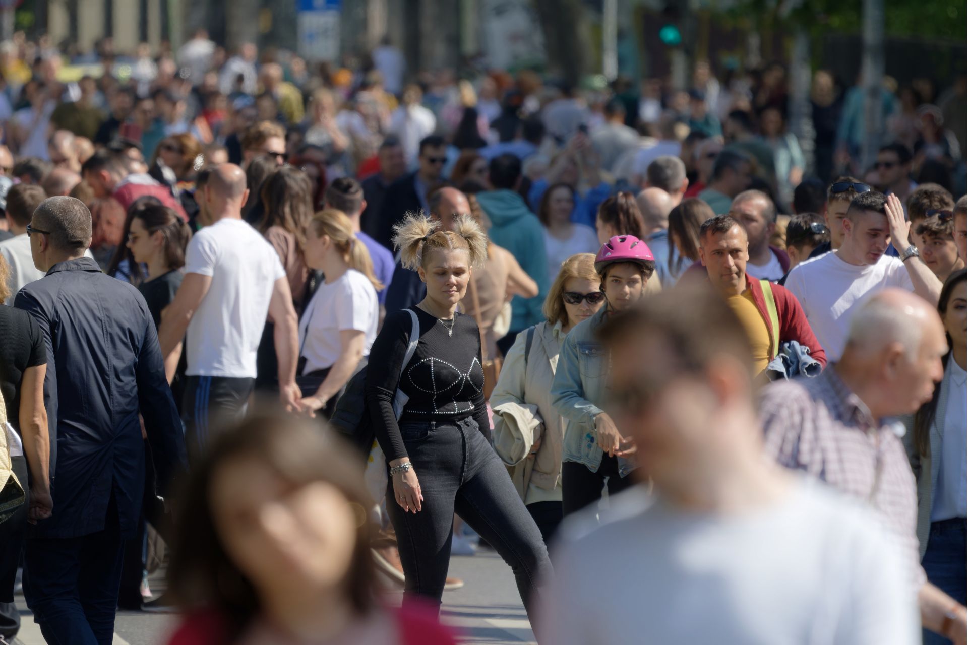 Crowd of pedestrians walking along a busy city street