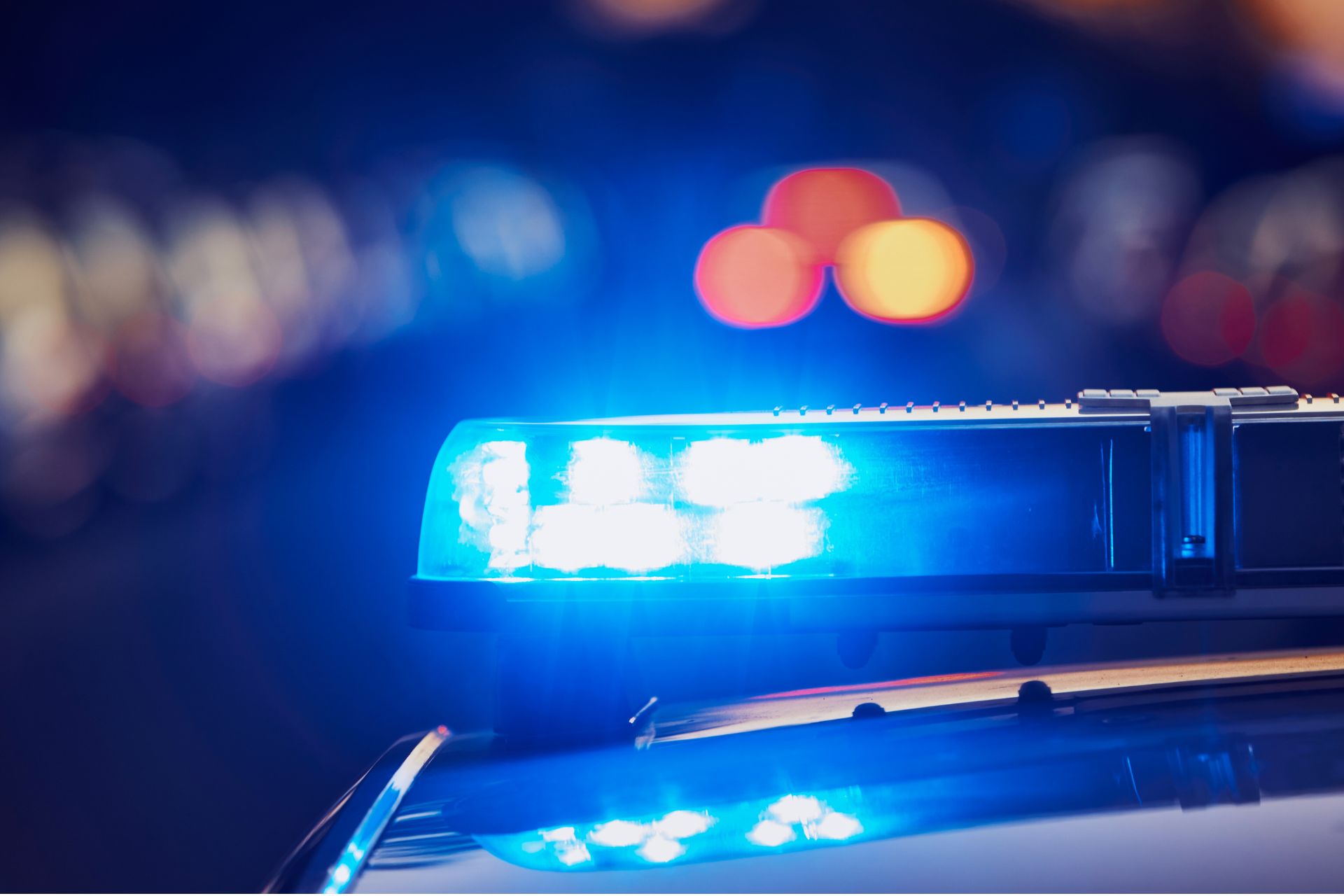 Flashing blue lights on top of a police vehicle at night